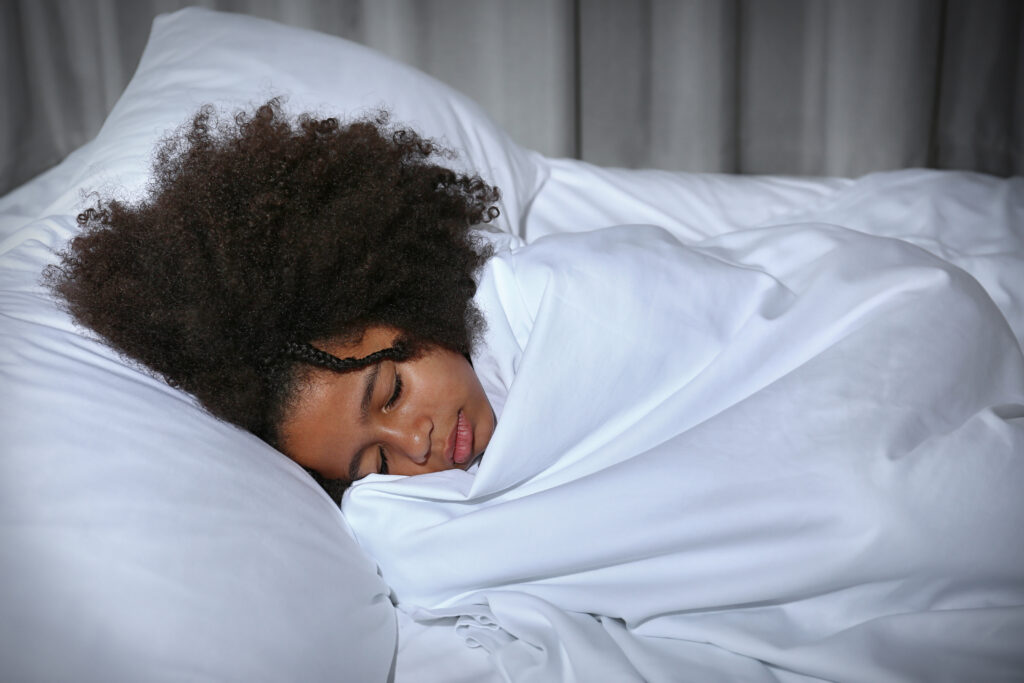 Young girl sleeping in bed